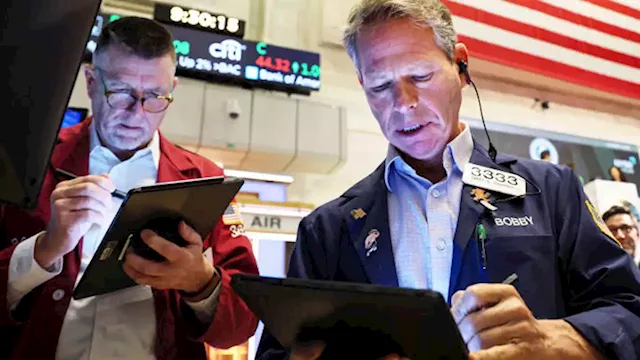 Dow closes up more than 300 points as strong earnings boost stocks in choppy market