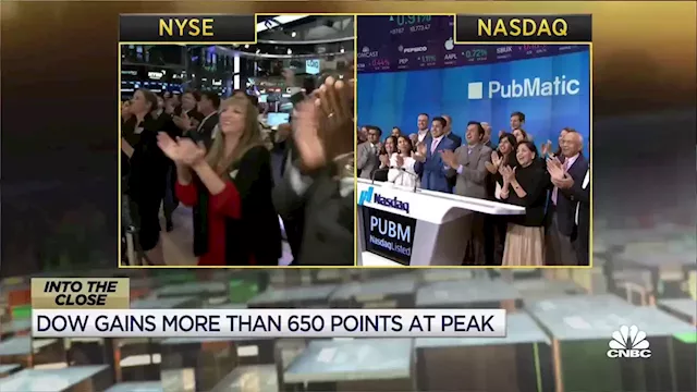 Dow closes up more than 300 points as strong earnings boost stocks in choppy market