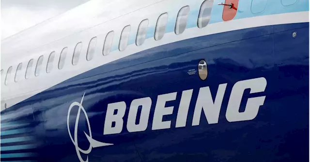 Boeing takes $2.8 bln hit in defense business, keeps cash flow goal