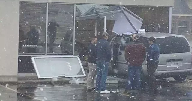 Employee killed after van crashes into business