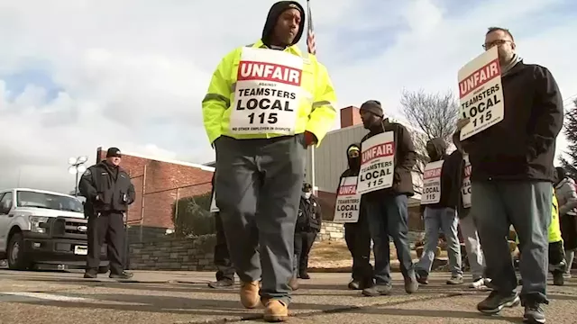 Waste Management workers hit picket line outside company's Camden headquarters