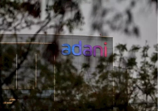 Adani group firms pledge shares for lenders of flagship company