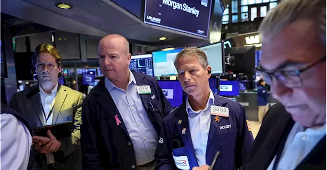 Wall St falls on downbeat earnings, interest rate jitters