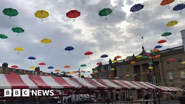 Hundreds of brightly-coloured umbrellas appear above market