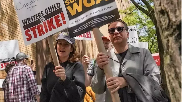 Hollywood actors join screenwriters on strike in first joint walkout since 1960, halting production across industry