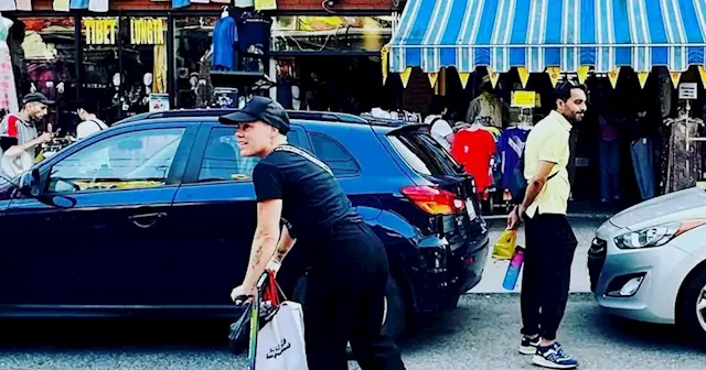 Pink spotted riding scooter around Kensington Market in Toronto