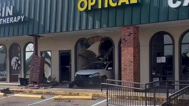 Dramatic video shows car slam into optical business, drive away from wreckage