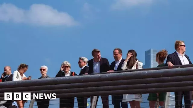 Millennium Bridge: Business people protest with queue for climate