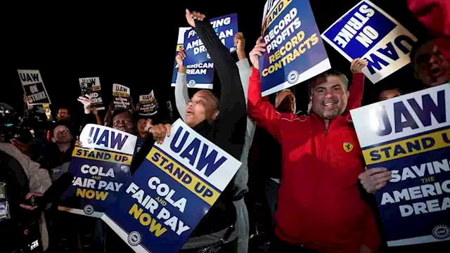 Workers strike at all 3 Detroit automakers, a new tactic to squeeze companies for better pay