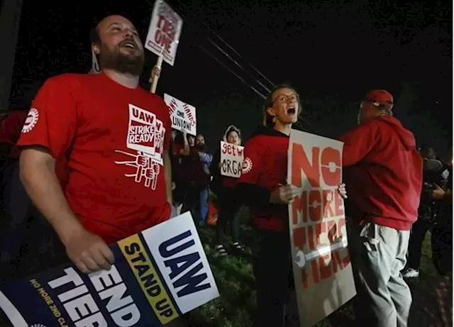 Workers strike at all 3 Detroit automakers, a new tactic to squeeze companies for better pay