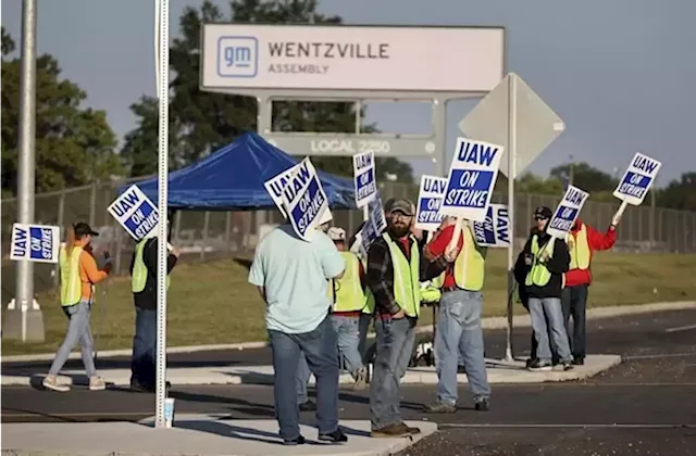 Workers strike at all 3 Detroit automakers in a battle for a bigger share of industry profits