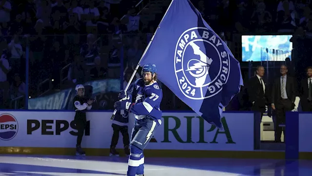 Power company workers get a standing ovation during the Lightning's hurricane-delayed home opener