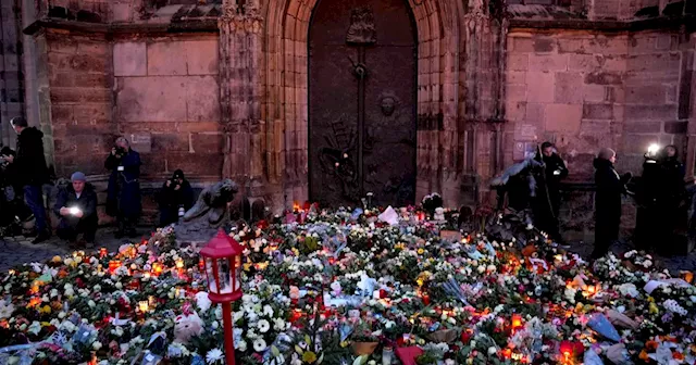 Germans mourn the 5 killed and 200 injured in the apparent attack on a Christmas market