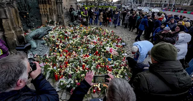 Germans mourn the 5 killed and 200 injured in the apparent attack on a Christmas market