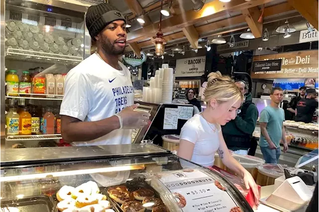 Sixers guard Buddy Hield worked the counter at Beiler’s Doughnuts in Reading Terminal Market