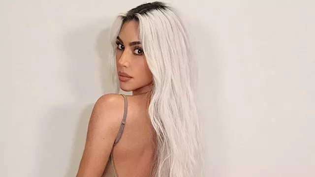 Kim Kardashian's company Skims reveals she is a size SMALL in a nude nightie that displays her...