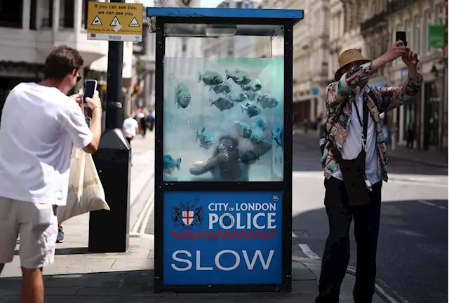 Banksy's fishy business: New artwork series turns police box into giant aquarium in London