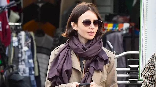 Emily in... Shepherd's Bush Market! Makeup free Lily Collins looks effortlessly chic in a trench...