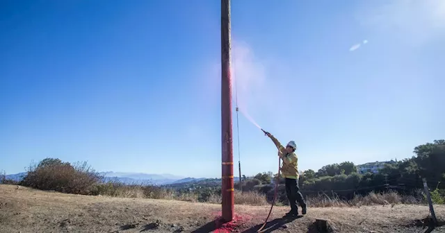 Power companies douse Los Angeles power poles with retardant to protect power grid during fires